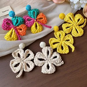Colorful raffia woven flower earrings in handmade bohemian vacation style
