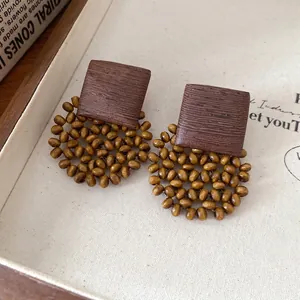 Bohemian square beaded stud earrings with French vintage style on canvas background