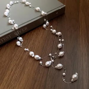 Elegant French style irregular baroque pearl triple layered necklace for women on wood