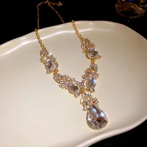 Close-up of luxury water drop pendant necklace with sparkling geometric crystals
