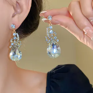 Elegant teardrop earrings with crystals, shown worn for detailed texture and sparkle.
