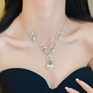 Detailed macro view of an elegant geometric water drop diamond necklace worn by a model