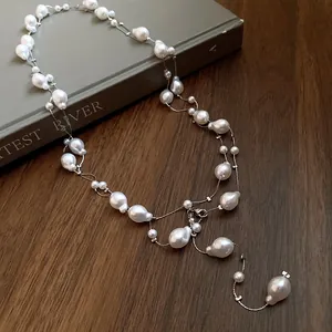 Macro detail view of an elegant three-layer necklace with irregular baroque pearls