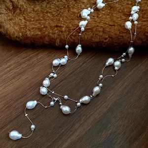 Detailed macro view of a three-layer necklace featuring irregular baroque pearls