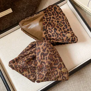 Macro detail of high-quality leopard print triangle shark hair clips on a white tray