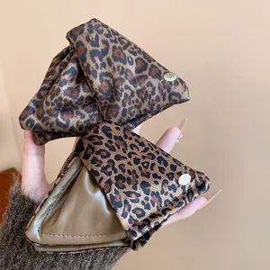 Detailed view of large triangular leopard print hair claws with leather patchwork