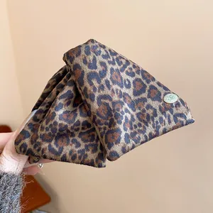 Detail shot of a large Maillard leopard print triangular hair claw clip for thick hair