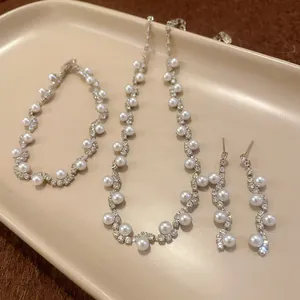 Elegant irregular pearl and rhinestone jewelry set including necklace, bracelet, and earrings