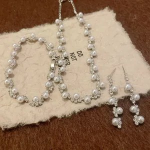 Close-up of elegant irregular pearl and rhinestone jewelry set including necklace
