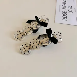 Close-up of sweet Korean heart hair clips with black polka dots and bows
