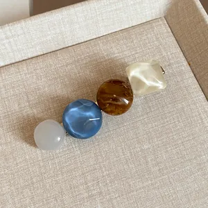 Close-up of a Korean style hair clip featuring colorful resin beads and marble patterns.