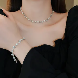 Detailed view of an elegant irregular pearl and rhinestone bracelet and necklace set