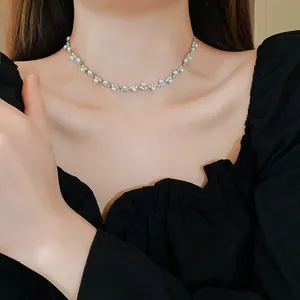 Elegant vintage-style pearl and rhinestone choker necklace worn by a model in a detailed view