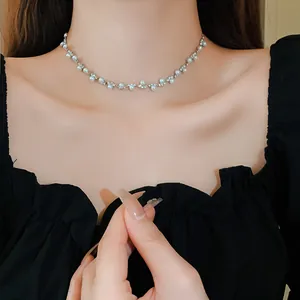 Elegant pearl and rhinestone choker necklace shown in detail on a female model's neck