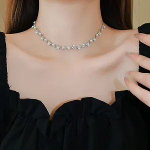 Elegant silver-tone choker necklace featuring white pearls and sparkling rhinestones on model