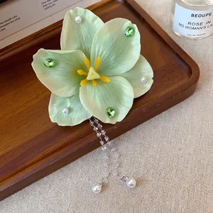 Elegant light green fabric flower hair clip with rhinestone tassels for vacation style