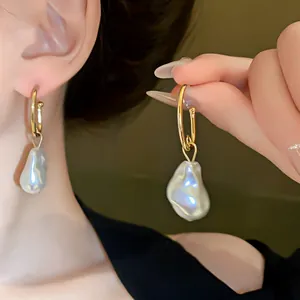 Detailed view of french style irregular baroque pearl drop hoop earrings for women