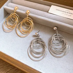 Close-up of gold and silver multi-hoop earrings displayed in a jewelry tray