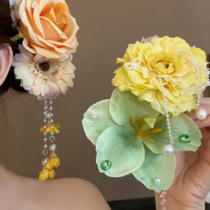 Close-up of floral hair clips with elegant pearl tassels and intricate fabric petals