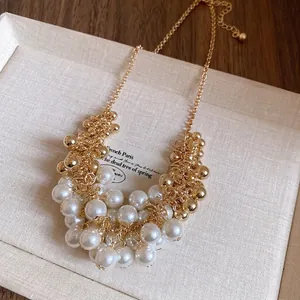 Elegant vintage French style pearl tassel necklace with gold beads on fine chain link.