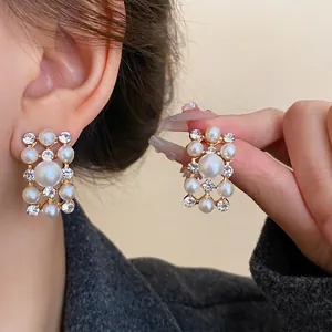 Elegant French retro rectangular earrings featuring pearls and clear rhinestones shown on model