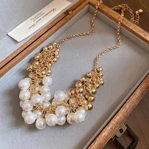French vintage pearl tassel necklace with gold beads in a wooden jewelry box