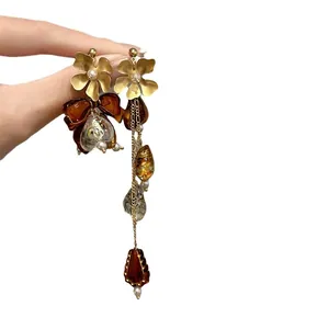 Vintage style asymmetrical flower and bow dangle earrings with amber resin beads for women.