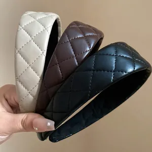 Detail of quilted leather padded headbands in beige, brown, and black colors.