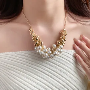 Detailed close-up of a French vintage necklace featuring clustered pearls and gold beads