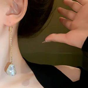 Detailed shot of elegant French style irregular pearl tassel drop earrings for women