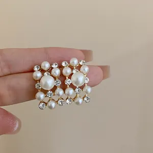 Detailed macro view of French vintage geometric earrings with pearls and rhinestones