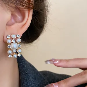 Close-up detail of French vintage style rectangular earring featuring pearls and rhinestones