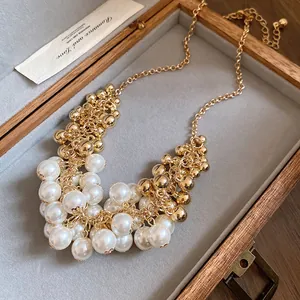 Elegant French retro necklace with white pearls and gold bead tassels in a box