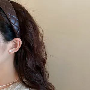 Close-up of a vintage brown quilted leather headband on a model for a high skull look