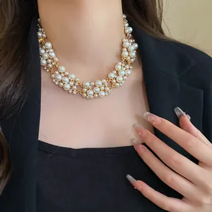 Detailed view of an elegant French retro multi-strand pearl and rhinestone choker necklace