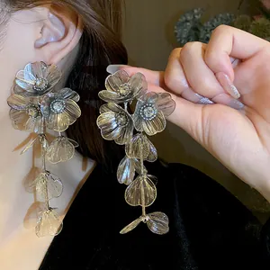 Detailed view of elegant silver flower tassel earrings with sparkling rhinestone accents