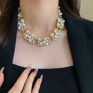 Close-up view of elegant French retro pearl and rhinestone choker necklace on a model