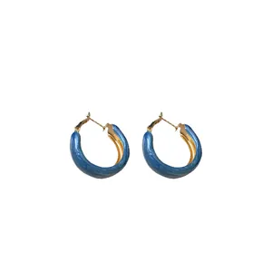 Elegant Klein Blue hoop earrings with gold interior for a stylish minimalist look