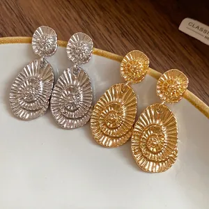 Elegant gold and silver oval textured drop earrings with high-end minimalist design