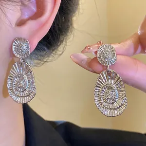 Textured silver oval drop earrings with elegant sunburst pattern engraving for women