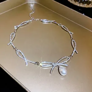 Luxury silver rhinestone bow-knot necklace featuring an elegant white pearl drop pendant