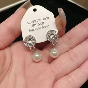 Elegant 925 silver drop earrings featuring a crystal-studded circle and white pearl
