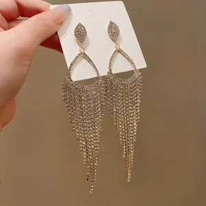 Close-up view of elegant teardrop tassel earrings with sparkling rhinestone crystals