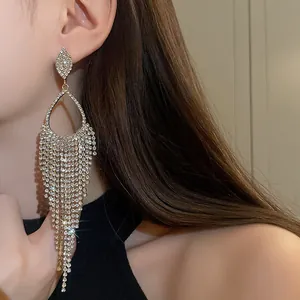Elegant silver needle rhinestone teardrop tassel earrings shown as a close-up on model