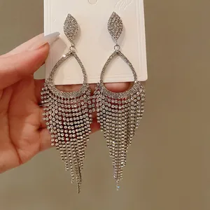 Detailed macro view of elegant silver rhinestone waterdrop tassel dangling earrings