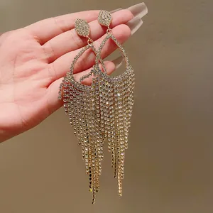 Elegant gold-tone tassel earrings with sparkling rhinestones in a water-drop design.