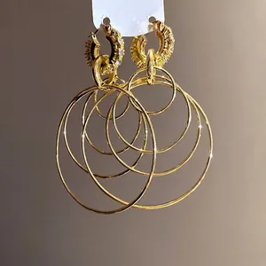 Elegant multi-layered gold hoop earrings featuring sparkling rhinestone-encrusted top circles