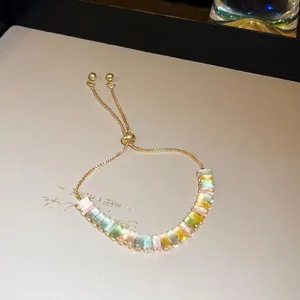 Adjustable gold-toned bracelet featuring vibrant colorful geometric cubic zirconia stones