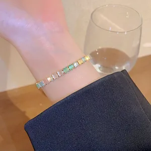 Close-up detail of a minimalist colorful zircon adjustable bracelet on model wrist