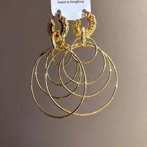 Detailed view of gold multi-layer hoop earrings with sparkling rhinestone accents